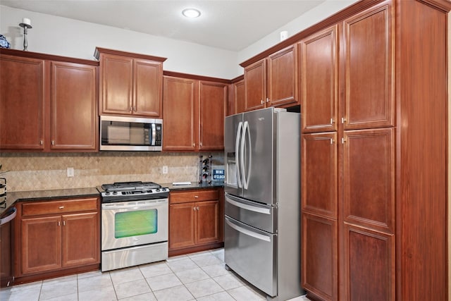 1967 Luther Rd, Irving, TX 75063 - kitchen with dark stone counters, light tile patterned flooring, stainless steel appliances, brown cabinets, and decorative backsplash