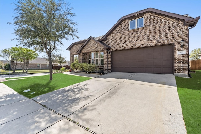 500 Harding Ln, Lavon, TX 75166 - view of front facade with brick siding, concrete driveway, and an attached garage