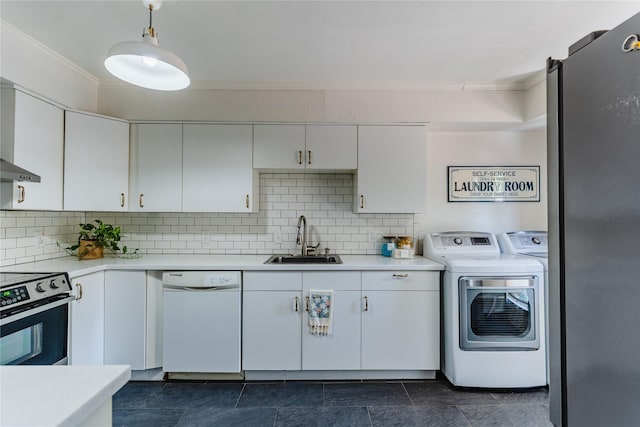 kitchen featuring crown molding, electric range, washing machine and clothes dryer, a sink, and white dishwasher
