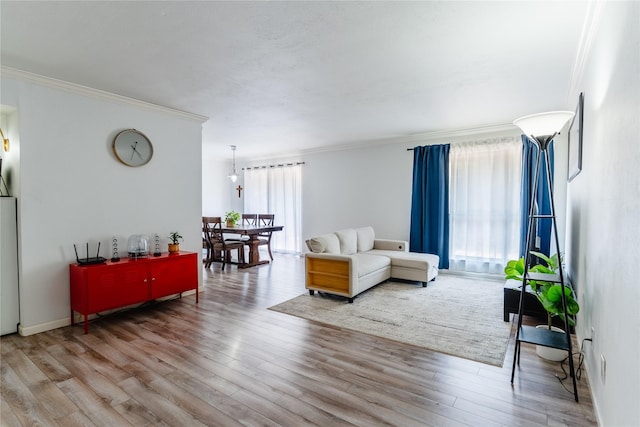 living room with crown molding and wood finished floors