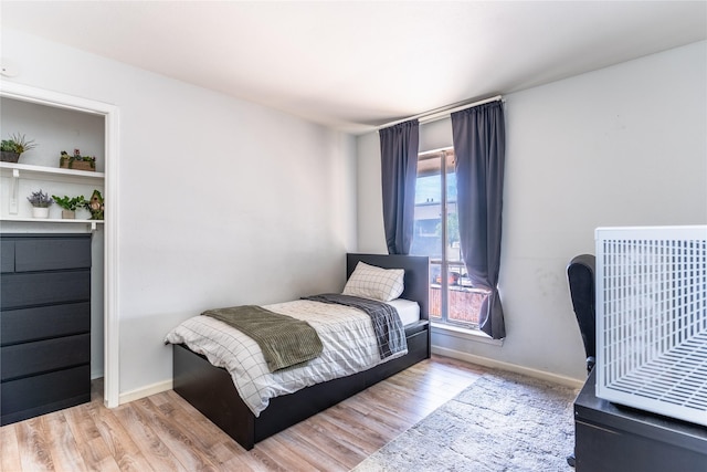 bedroom featuring baseboards and wood finished floors