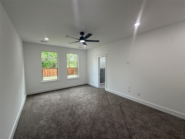 empty room with visible vents, baseboards, dark colored carpet, ceiling fan, and recessed lighting