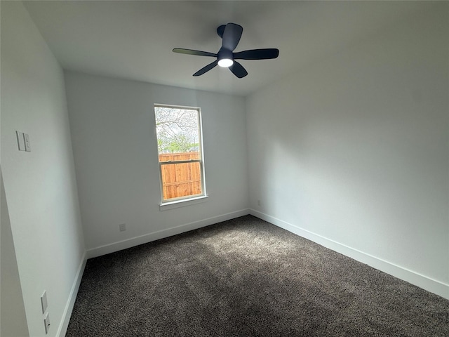unfurnished room featuring dark carpet, baseboards, and ceiling fan