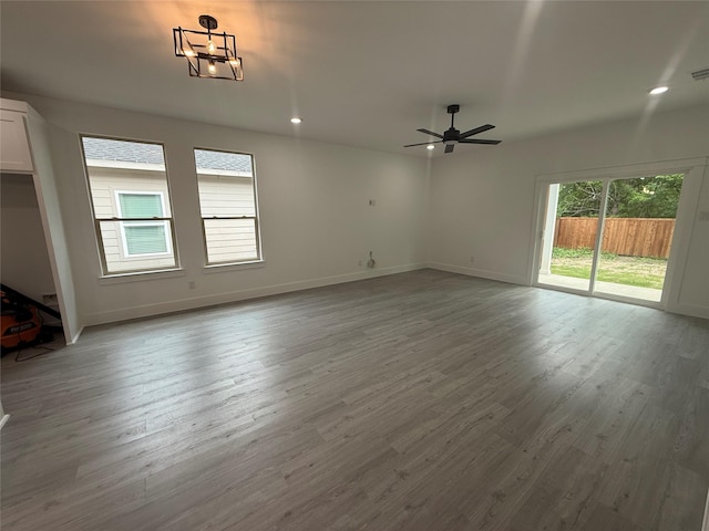 unfurnished living room featuring recessed lighting, baseboards, a ceiling fan, and wood finished floors