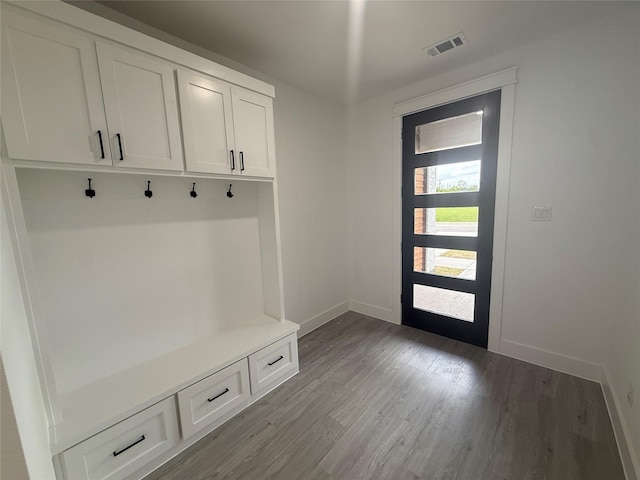mudroom featuring visible vents, baseboards, and wood finished floors
