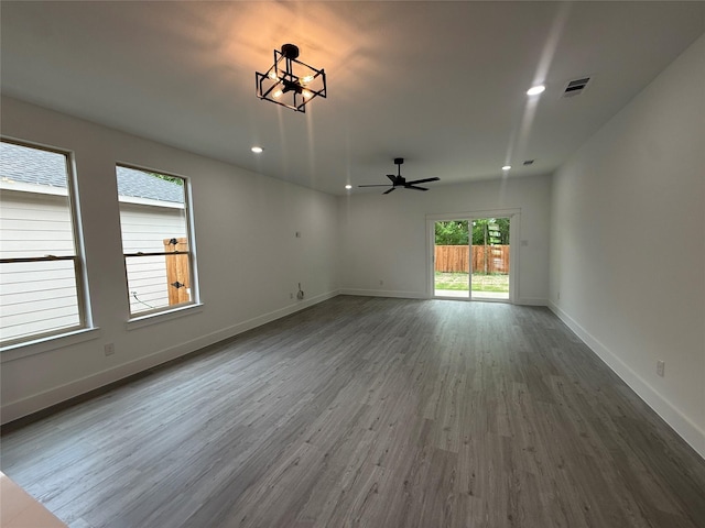 empty room featuring visible vents, baseboards, a ceiling fan, recessed lighting, and wood finished floors