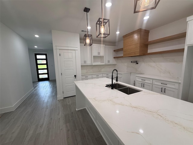 kitchen with dark wood finished floors, white cabinetry, open shelves, decorative backsplash, and a sink