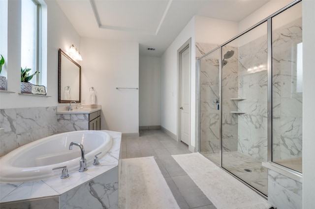 bathroom with visible vents, a garden tub, a marble finish shower, and vanity