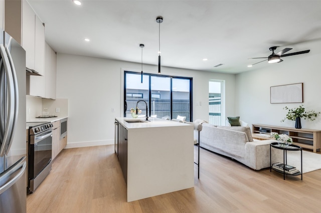 7312 Flyers Way, Dallas, TX 75235 - kitchen with appliances with stainless steel finishes, modern cabinets, light wood-type flooring, a sink, and recessed lighting