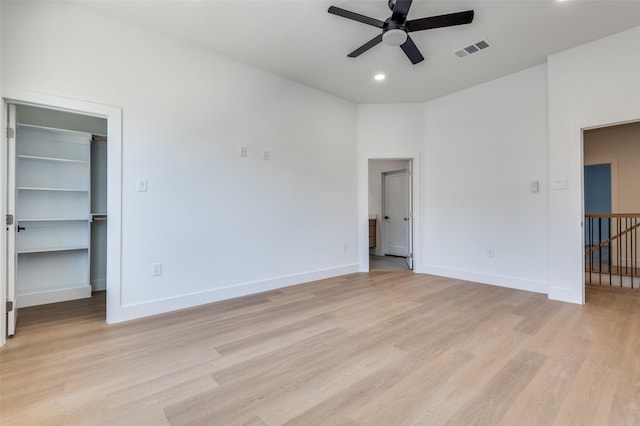 7312 Flyers Way, Dallas, TX 75235 - unfurnished bedroom featuring light wood-style flooring, baseboards, a spacious closet, recessed lighting, and ceiling fan