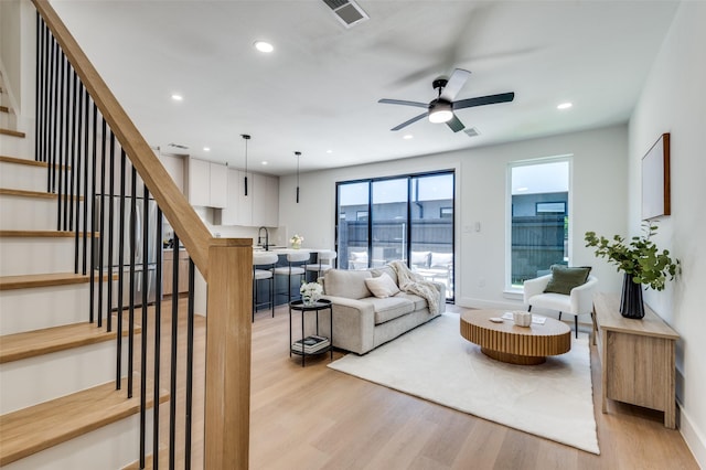 7312 Flyers Way, Dallas, TX 75235 - living area with light wood-style floors, stairway, recessed lighting, a ceiling fan, and baseboards