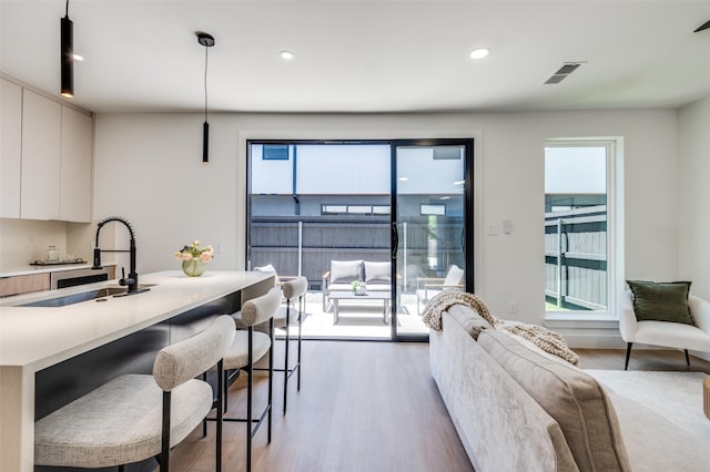 7312 Flyers Way, Dallas, TX 75235 - living area featuring light wood-style flooring, healthy amount of natural light, and recessed lighting