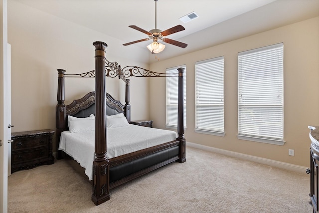 bedroom featuring visible vents, baseboards, ceiling fan, and light colored carpet