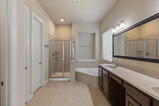 bathroom with visible vents, a sink, tile patterned floors, a stall shower, and a garden tub