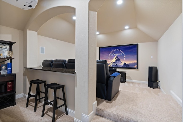 carpeted cinema room with baseboards and lofted ceiling