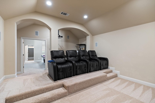 cinema featuring baseboards, visible vents, light colored carpet, and vaulted ceiling