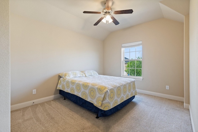 carpeted bedroom with ceiling fan, vaulted ceiling, and baseboards