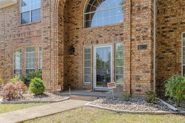 property entrance with brick siding
