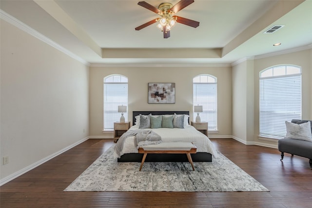 bedroom featuring a raised ceiling, visible vents, and dark wood-type flooring