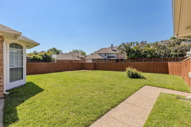 view of yard with a residential view and a fenced backyard