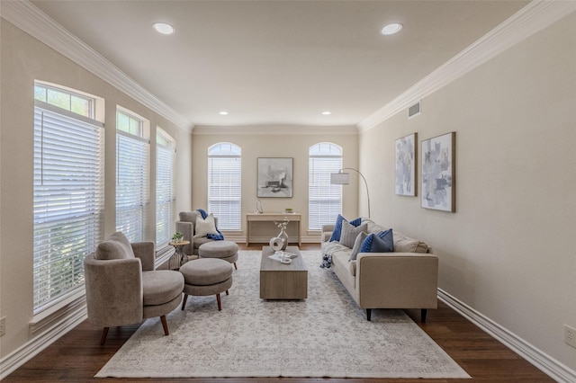 living area featuring dark wood-type flooring, visible vents, and a healthy amount of sunlight
