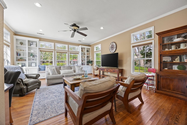 living room with recessed lighting, visible vents, light wood-type flooring, crown molding, and ceiling fan