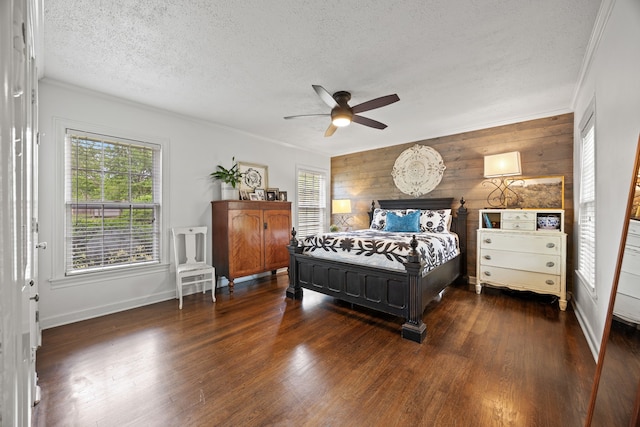 bedroom featuring baseboards, a textured ceiling, ornamental molding, and dark wood finished floors