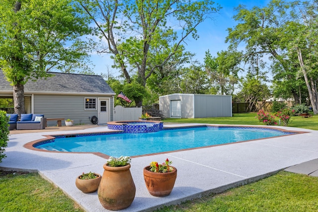 view of pool featuring a lawn, an outbuilding, a patio area, and a fenced backyard