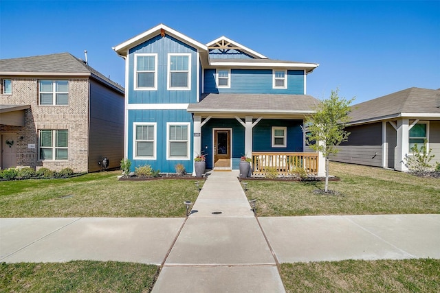 view of front of home with a front yard, a porch, and board and batten siding