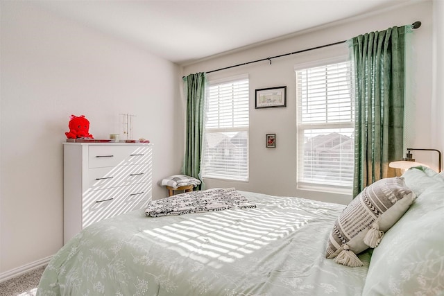 bedroom featuring carpet flooring and baseboards