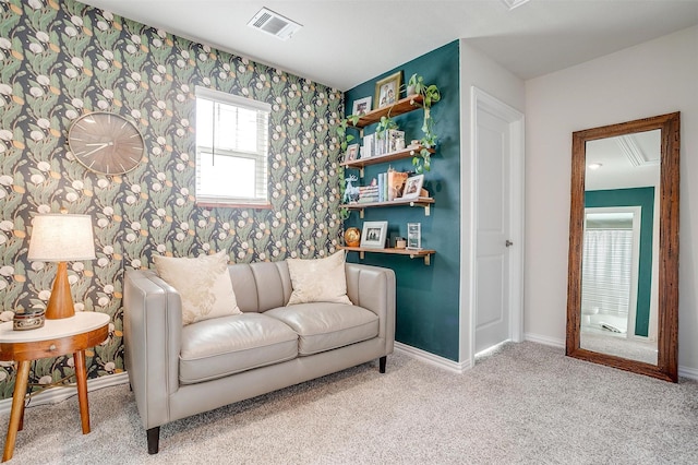 sitting room featuring baseboards, wallpapered walls, carpet flooring, attic access, and visible vents