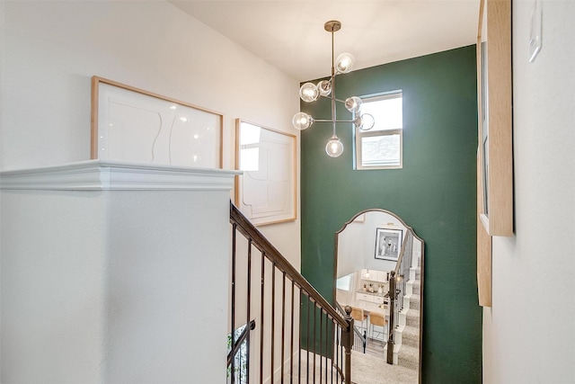 staircase with carpet and an inviting chandelier