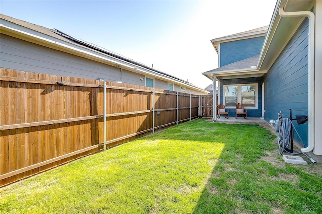 view of yard with a patio area and a fenced backyard