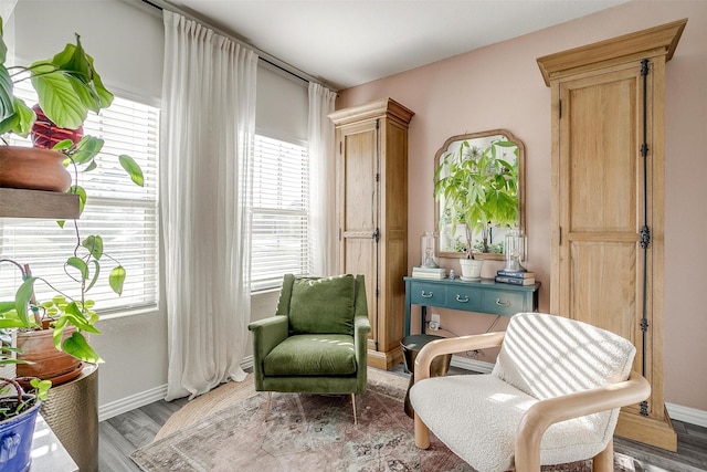living area with light wood-style floors and baseboards