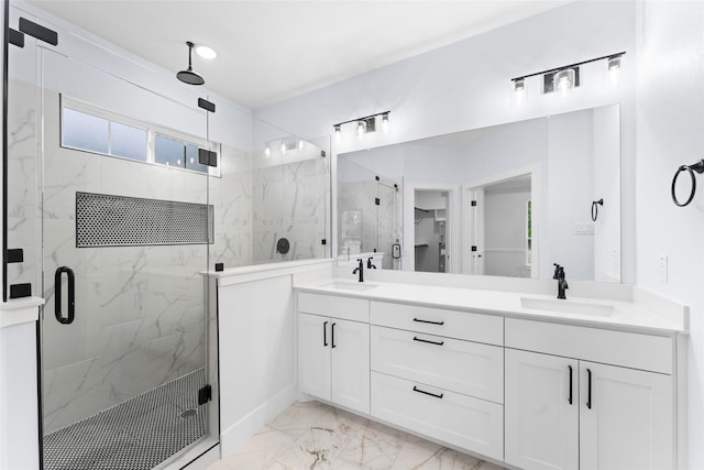 bathroom with double vanity, marble finish floor, a sink, and a marble finish shower