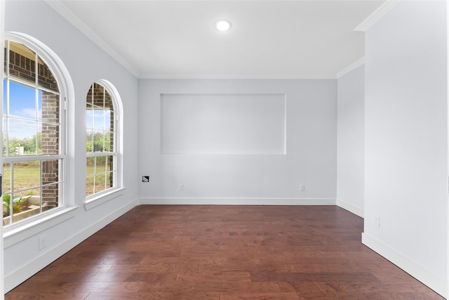 empty room with ornamental molding, wood finished floors, and a healthy amount of sunlight