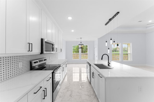 kitchen with recessed lighting, marble finish floor, a sink, stainless steel appliances, and decorative backsplash