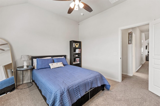 carpeted bedroom featuring a ceiling fan, vaulted ceiling, and baseboards