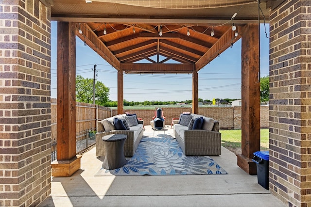 view of patio with outdoor lounge area, a gazebo, and a fenced backyard