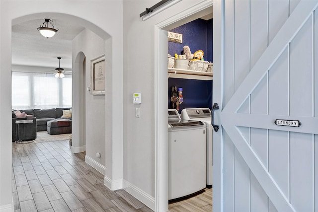 10205 Fox Springs Dr, Fort Worth, TX 76131 - hall featuring washer and dryer, arched walkways, light wood-type flooring, and baseboards