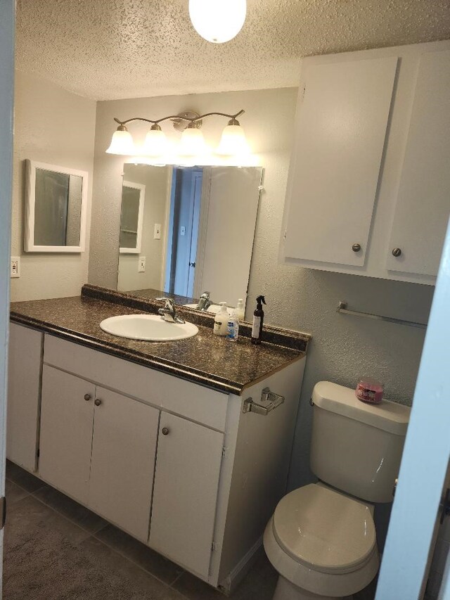 4614 Country Creek Dr Unit 1167, Dallas, TX 75236 - bathroom with tile patterned flooring, vanity, a textured ceiling, and toilet