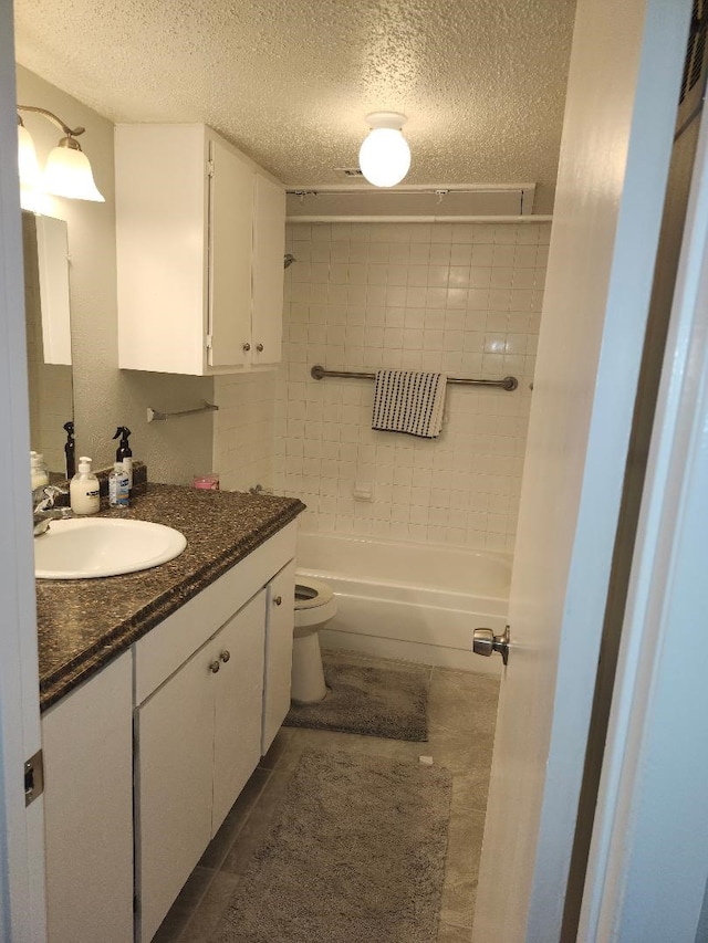 4614 Country Creek Dr Unit 1167, Dallas, TX 75236 - bathroom with tub / shower combination, a textured ceiling, toilet, and vanity