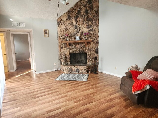 4614 Country Creek Dr Unit 1167, Dallas, TX 75236 - living room featuring visible vents, a textured ceiling, baseboards, and lofted ceiling