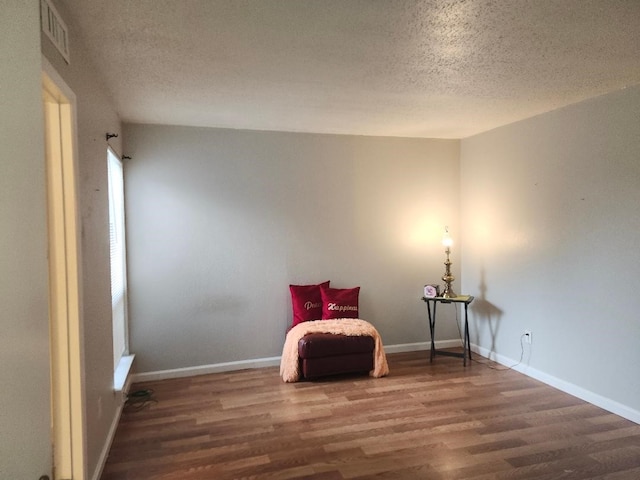 4614 Country Creek Dr Unit 1167, Dallas, TX 75236 - living area with visible vents, wood finished floors, and a textured ceiling