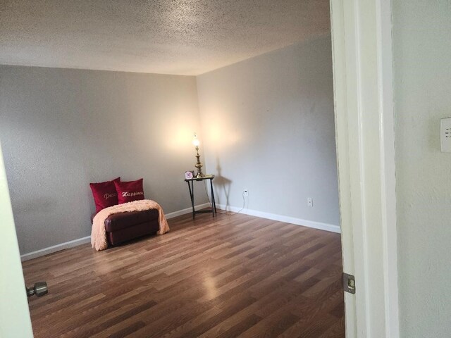 4614 Country Creek Dr Unit 1167, Dallas, TX 75236 - unfurnished room featuring baseboards, wood finished floors, and a textured ceiling