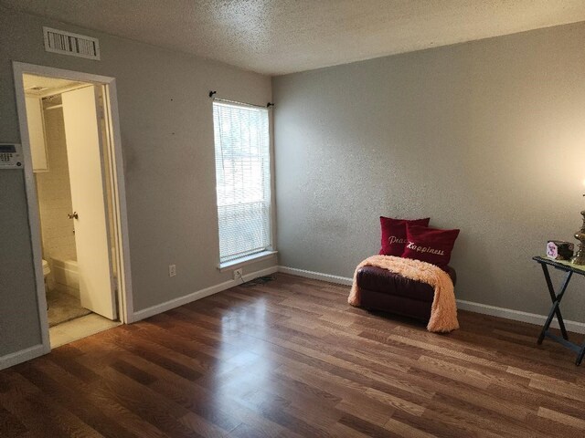 4614 Country Creek Dr Unit 1167, Dallas, TX 75236 - sitting room featuring wood finished floors, visible vents, a wealth of natural light, and a textured ceiling
