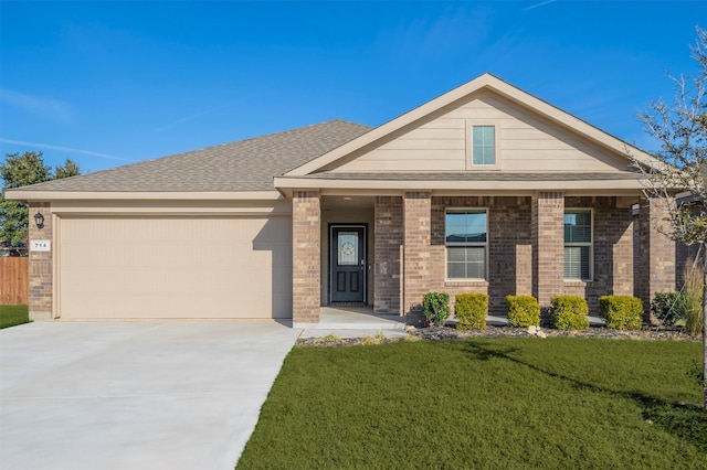 view of front of house with a garage, brick siding, driveway, and a front lawn