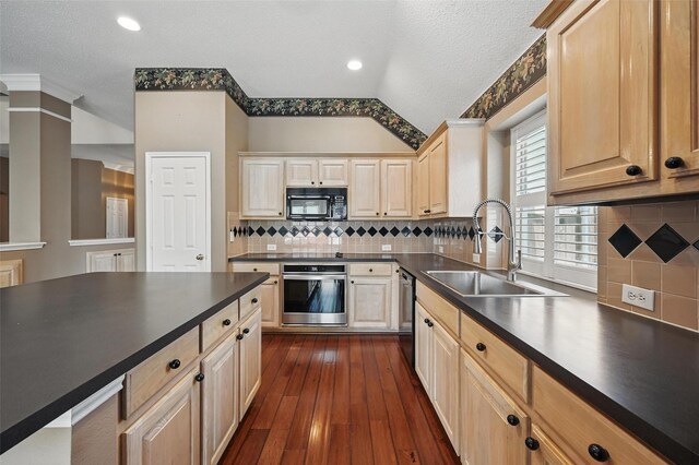 5320 Big Bend Dr, Fort Worth, TX 76137 - kitchen featuring a textured ceiling, dark countertops, appliances with stainless steel finishes, a sink, and light brown cabinetry