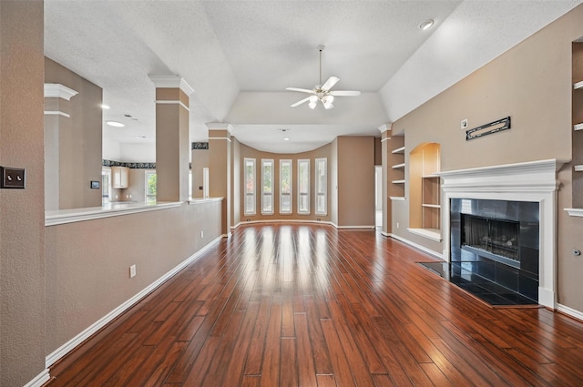 5320 Big Bend Dr, Fort Worth, TX 76137 - unfurnished living room featuring baseboards, a ceiling fan, built in shelves, and hardwood / wood-style flooring