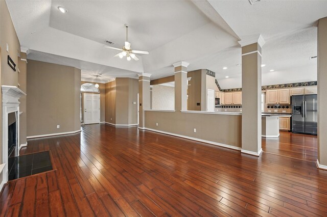 5320 Big Bend Dr, Fort Worth, TX 76137 - unfurnished living room with ornate columns, baseboards, a ceiling fan, and visible vents